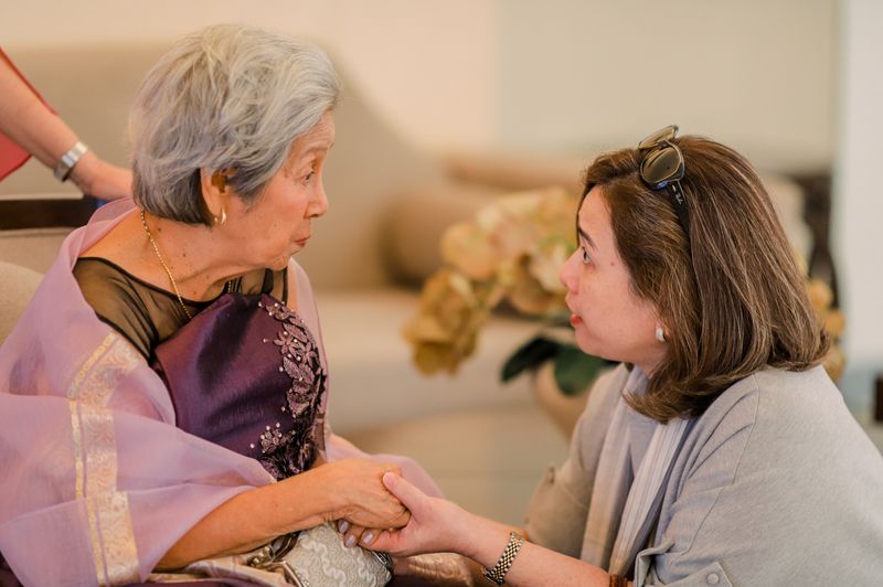 Adult daughter sharing a warm moment with her elderly mother