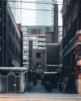 Urban alleyway scene capturing architectural mix in downtown Toronto.
