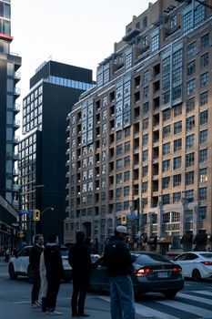 A busy Toronto city street with pedestrians and urban architecture, capturing everyday movement.