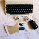 Vintage Typewriter with Blossom on White Bedspread