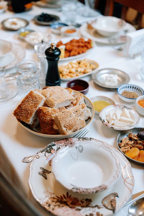 Free A lavish holiday spread featuring fresh baked bread, nuts, dips, and more on a beautifully set table. Stock Photo