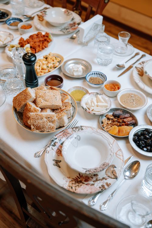 Free A beautifully arranged breakfast table with an array of diverse dishes and elegant tableware. Stock Photo