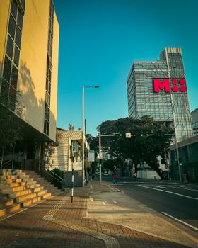 City street view featuring modern architecture under a clear blue sky.