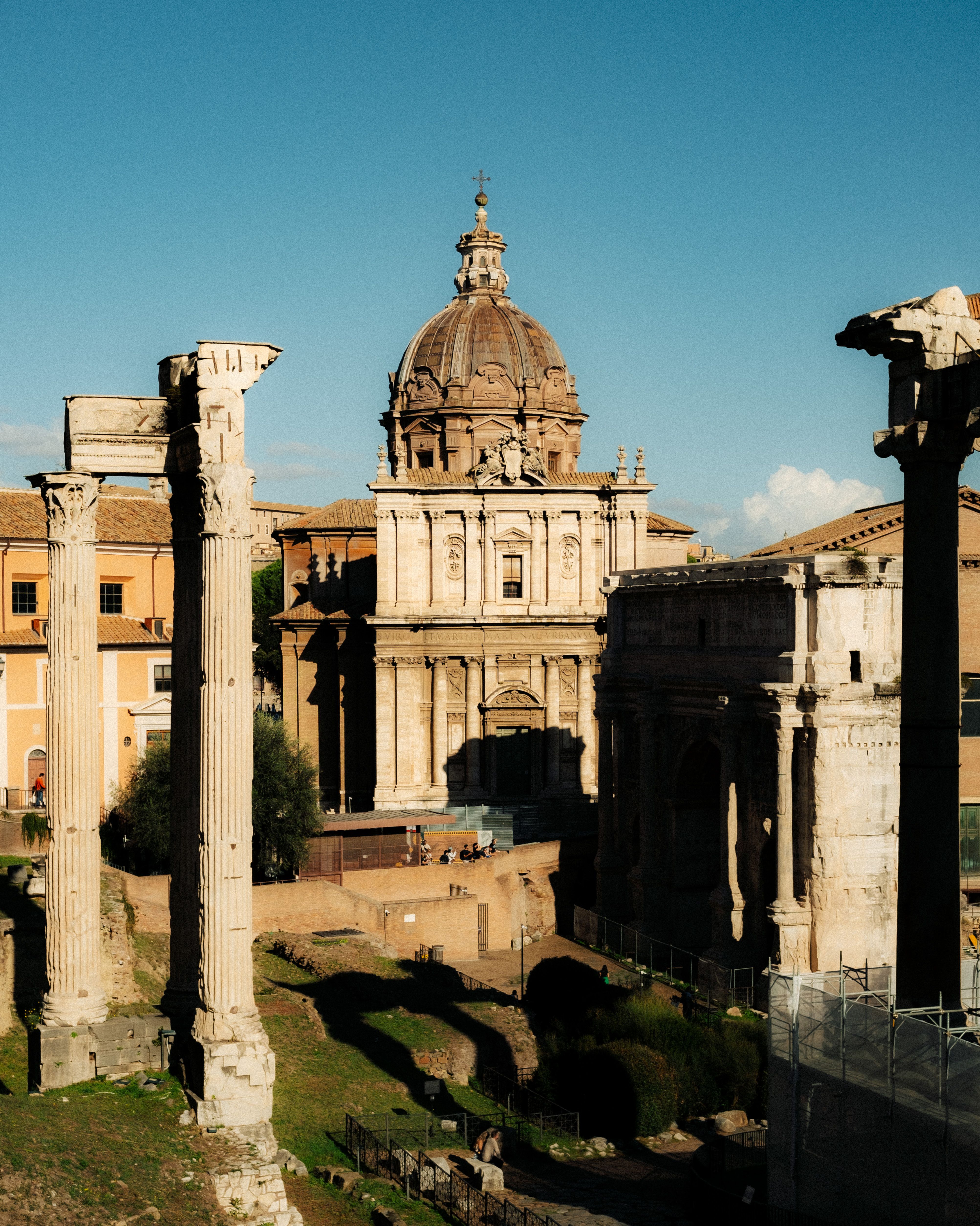 Explore the ancient ruins of the Roman Forum captured in vibrant daylight in Rome, Italy.