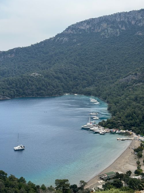 Free A breathtaking aerial shot of a yacht bay in Fethiye, surrounded by lush mountains and calm waters. Stock Photo
