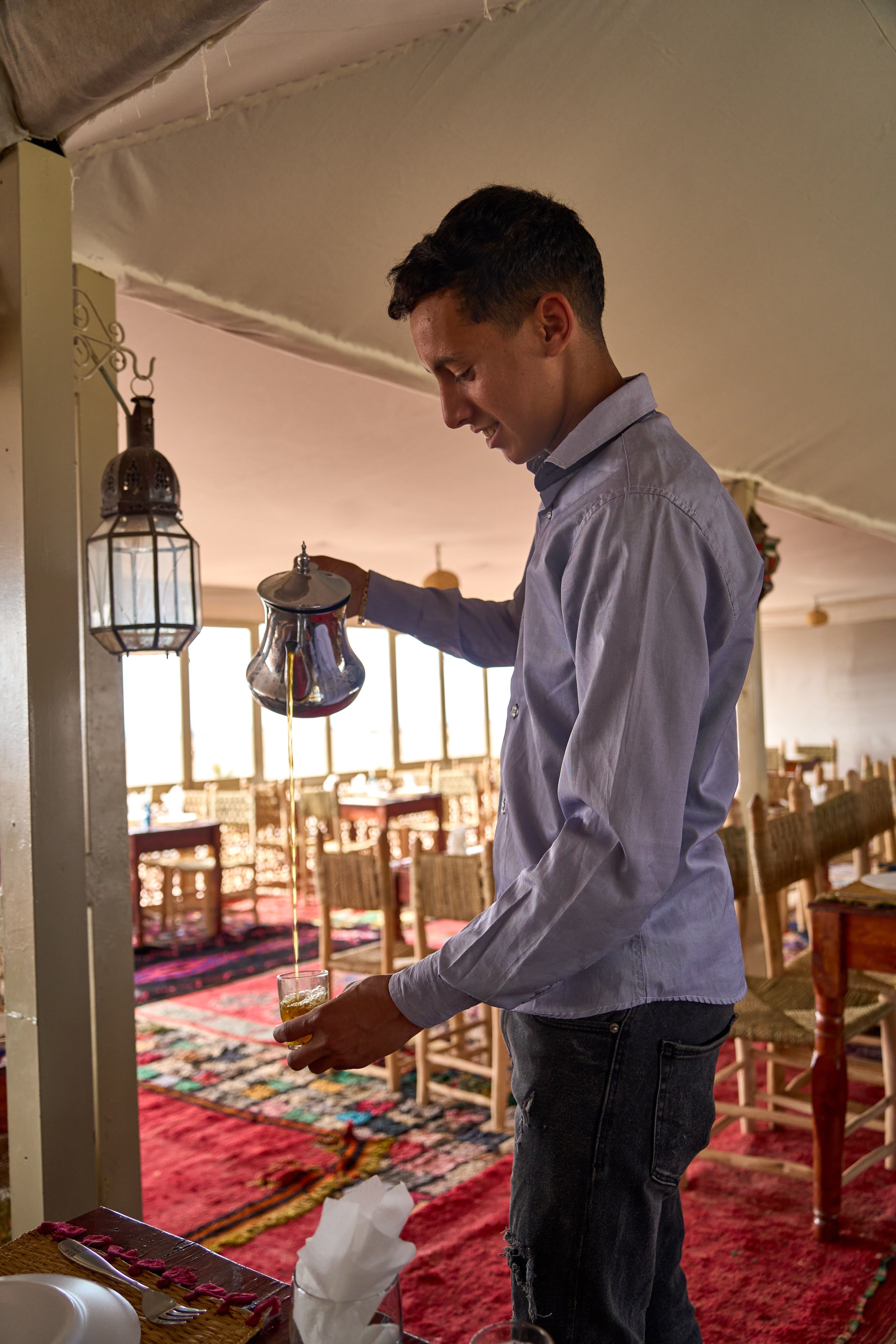 Mint tea being poured at a Moroccan desert camp