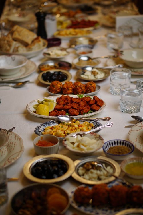 Free A beautifully arranged Turkish meal showcasing a variety of dishes on an elegantly set table in İzmir. Stock Photo