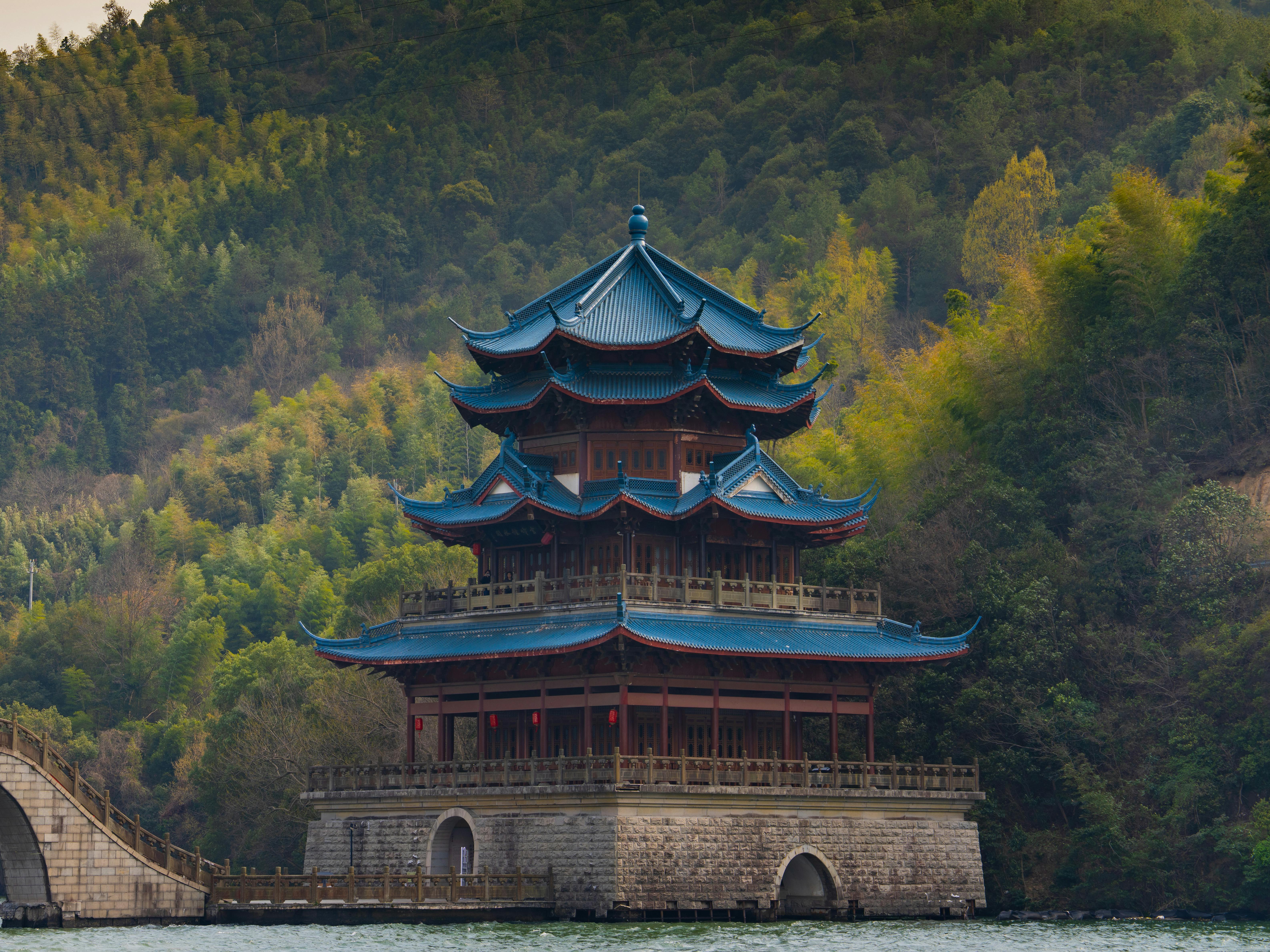 Free Stunning view of a traditional pagoda surrounded by lush forest, reflecting cultural heritage. Stock Photo