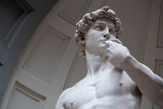 Close-up of Michelangelo's David sculpture displayed indoors in Florence, Italy.