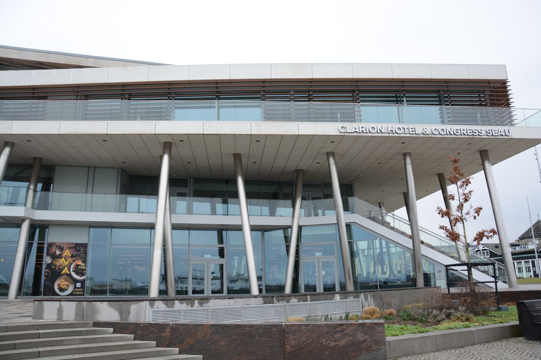 Front view of Clarion Hotel showcasing modern design and glass facade. Related image for 2024 Global Revenue and Distribution Masterclass.