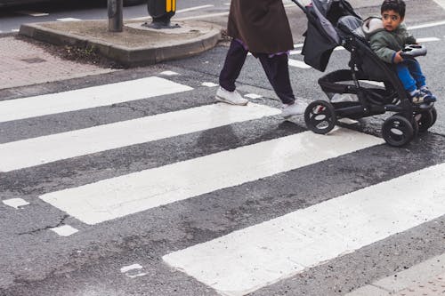 Person Pushing Stroller Crosswalk on Pedestrian Lane