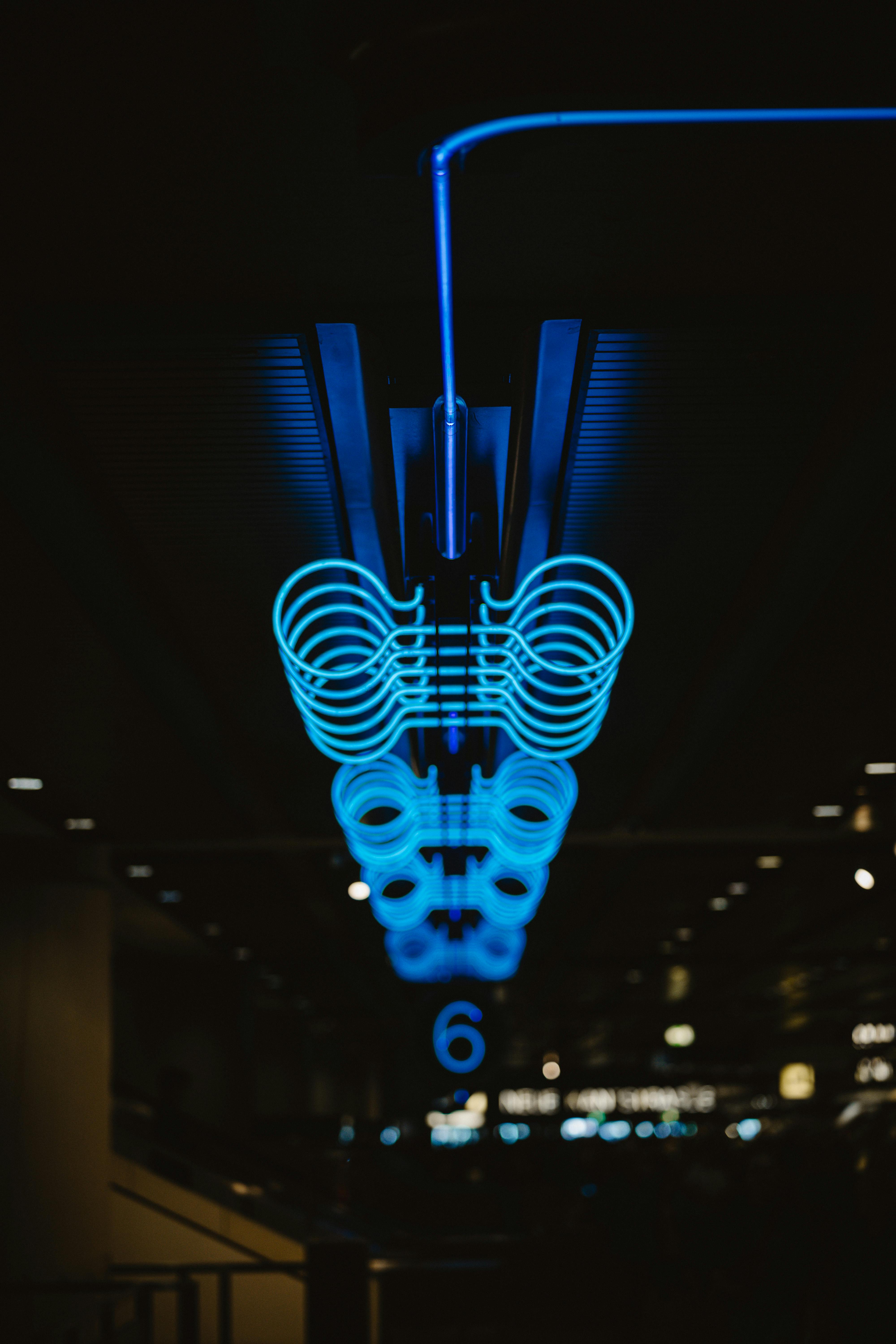 ingyenes Absztrakt felvétel egy világító kék neonfényről egy halványan megvilágított modern belső térben. Stockfotó