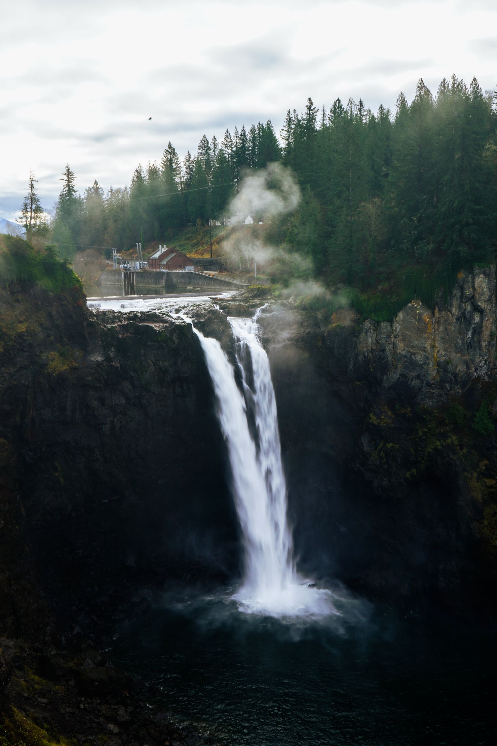 Photo of a Chain Link Fence Near a Waterfall · Free Stock Photo