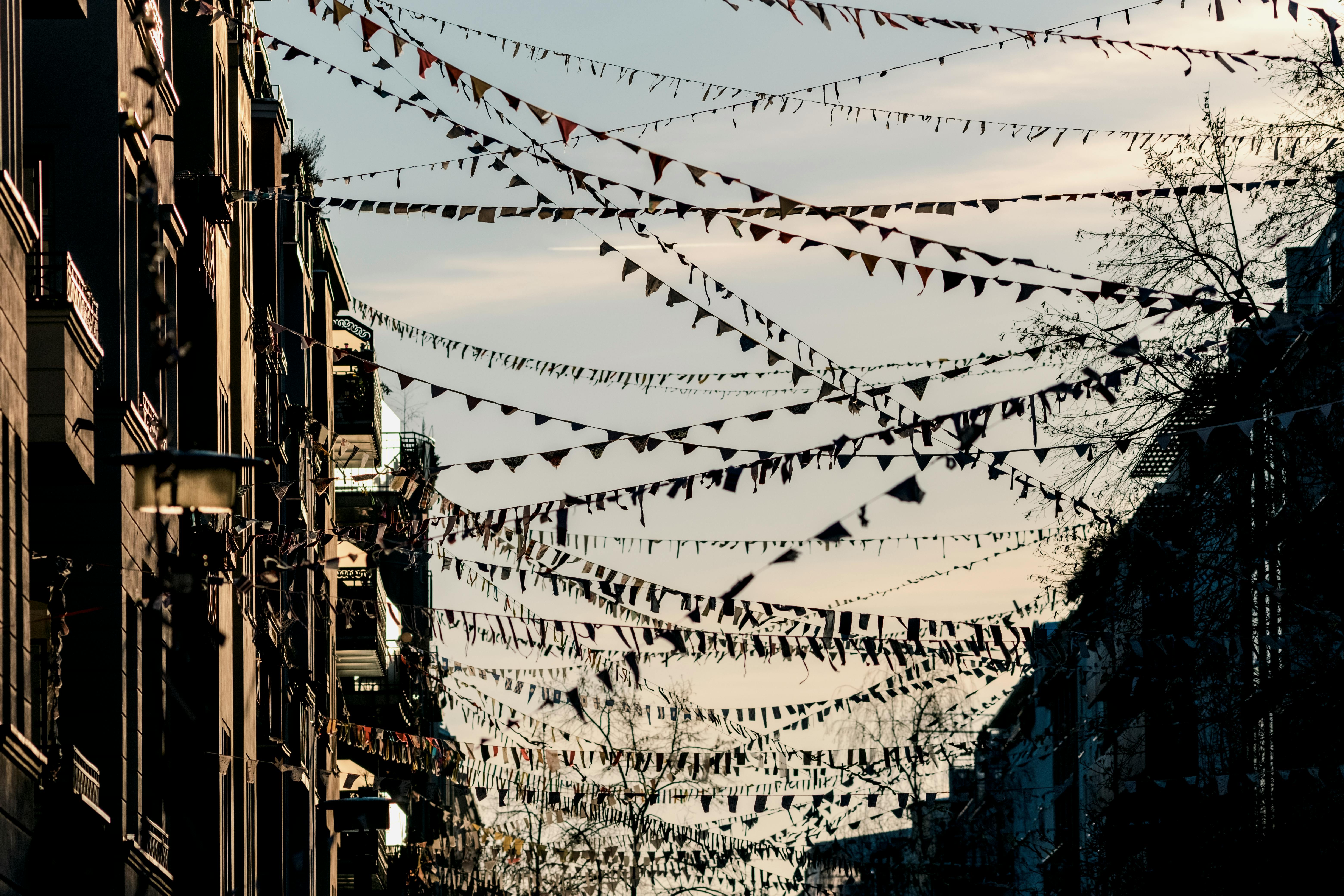 Free Street in Berlin adorned with festive bunting against a clear sky, creating a celebratory mood. Stock Photo