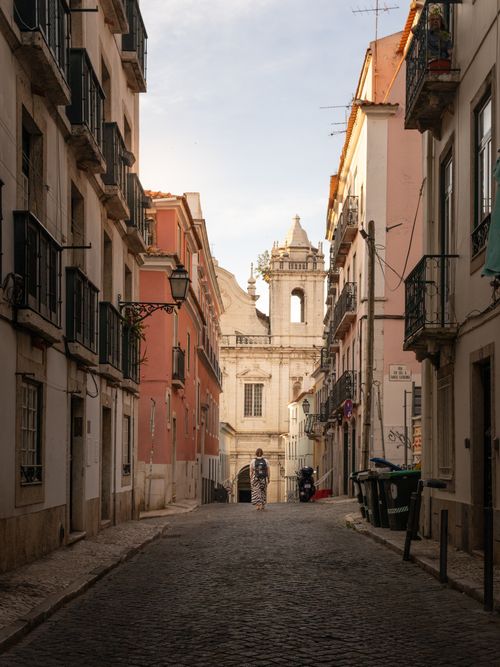 Free Picturesque street view in Lisbon, Portugal showcasing classic architecture and warm lighting. Stock Photo