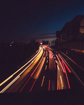 A captivating view of urban highway traffic light trails captured with a long exposure at night.