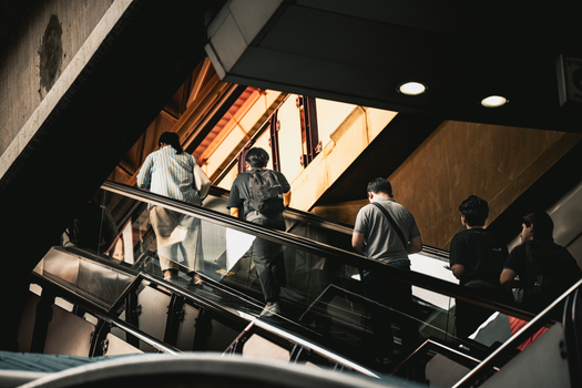 A dynamic city moment captured on an escalator in Bangkok, Thailand.