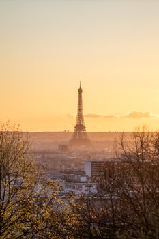 A scenic view of the Eiffel Tower during a serene sunset with the Paris skyline in the foreground.