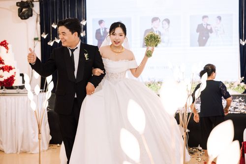 Free A happy bride and groom celebrating their wedding indoors with cheerful expressions and elegant attire. Stock Photo