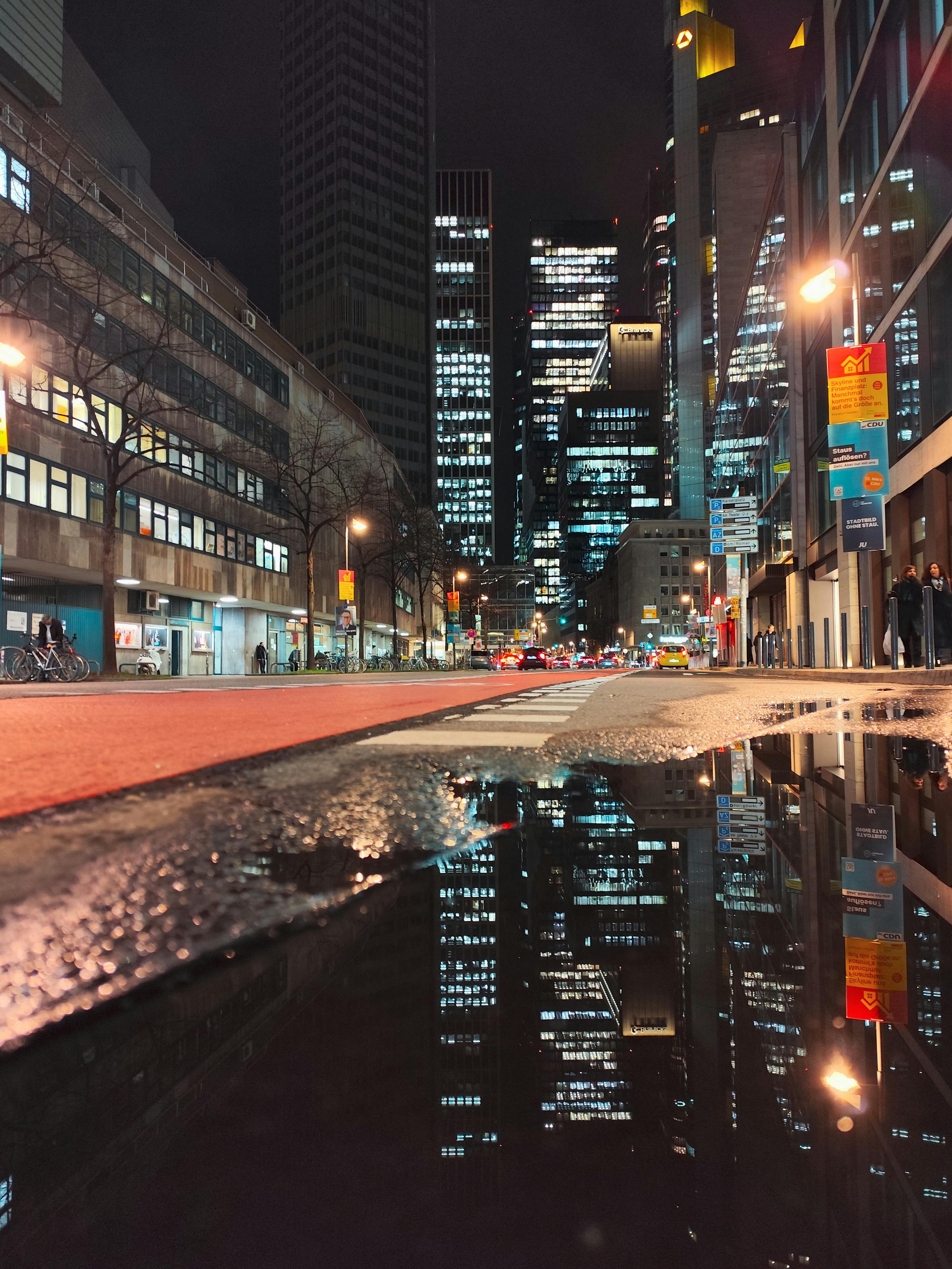 bezplatná Živý noční pohled na panorama Frankfurtu odrážející se v kalužích. Základová fotografie