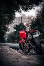 Red Superbike Parked on a Tree-Lined Street