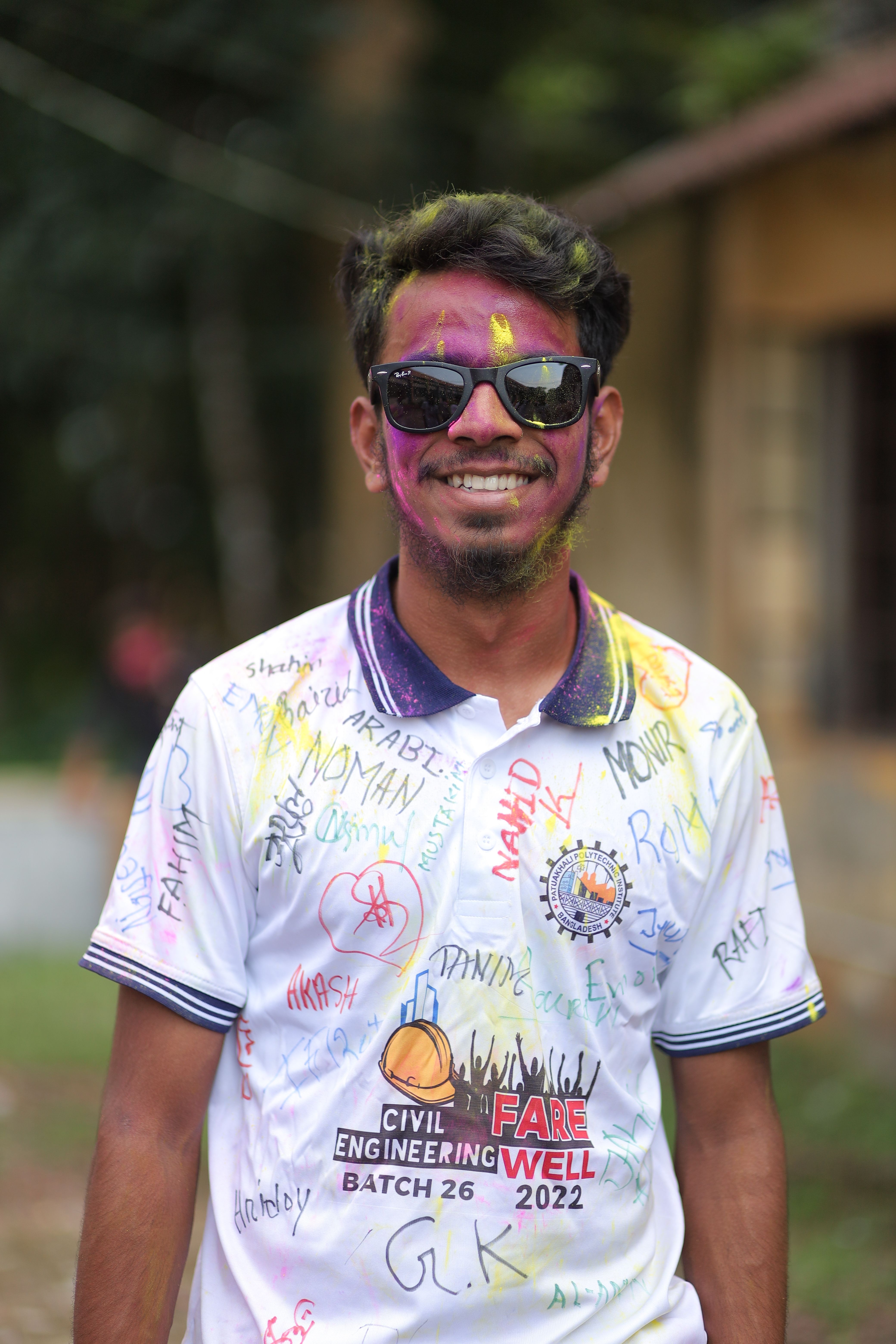 Young adult in vibrant colors celebrating a joyful occasion outdoors.
