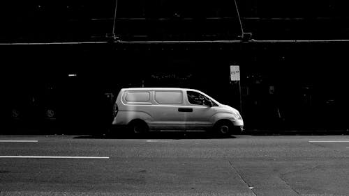 A Gray Scale Photo Of A Van