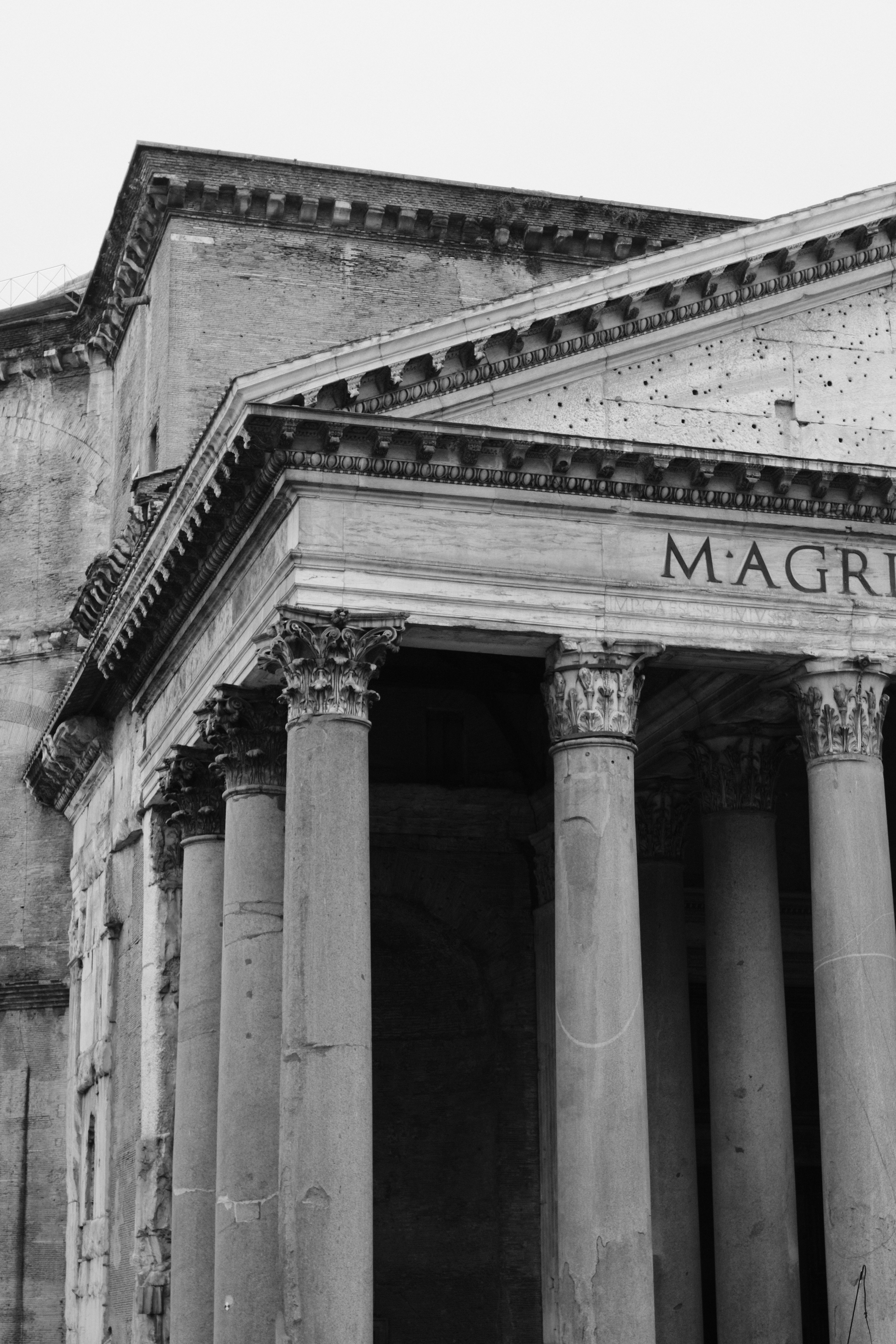 Black and white photograph of the Pantheon's iconic columns in Rome, Italy.
