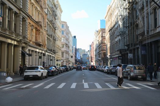 Serene moment on a bustling SoHo street in NYC, featuring classic architecture.
