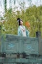 Elegant Woman in Traditional Hanfu on Stone Bridge