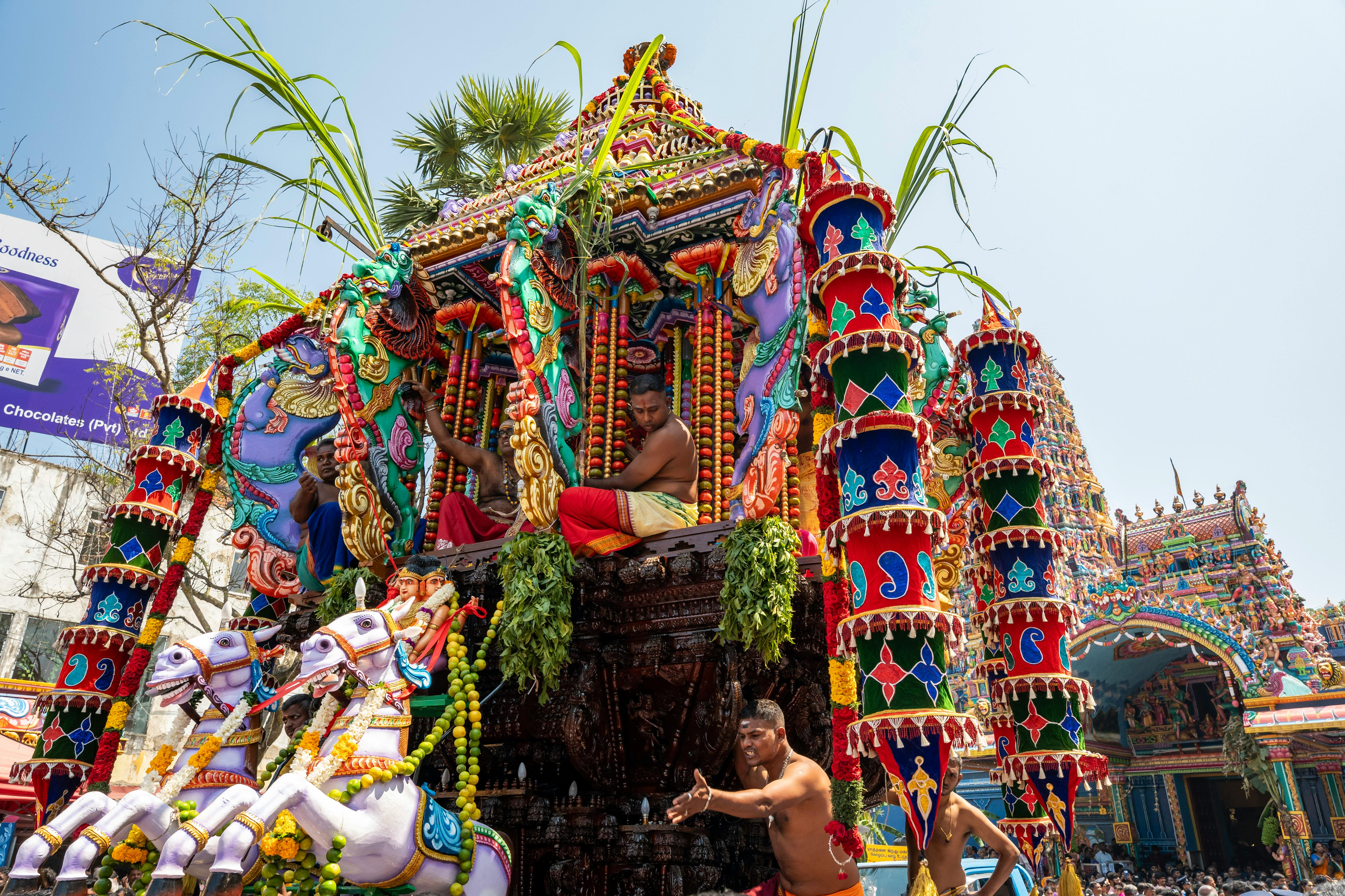 Okanda Devalaya Hindu temple showing ornate gopuram architecture and pilgrims during worship