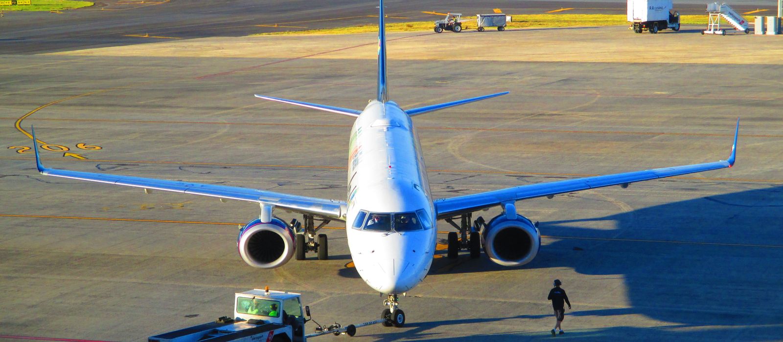Jetliner preparing for takeoff at Belo Horizonte Airport in Minas Gerais, Brazil. Clear day, vibrant scene.