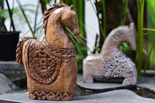 Free Beautifully carved wooden horse sculptures displayed outdoors, showcasing intricate patterns and craftsmanship. Stock Photo
