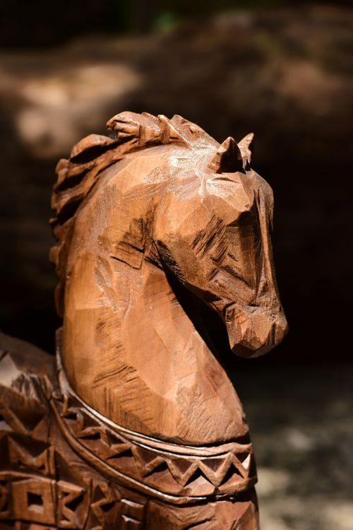 Free Close-up of an intricately carved wooden horse sculpture with ornate details. Stock Photo