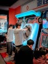 Teenage Boys Playing Arcade Rhythm Game