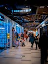 Bustling Shopping Mall with Neon Lights and Shoppers