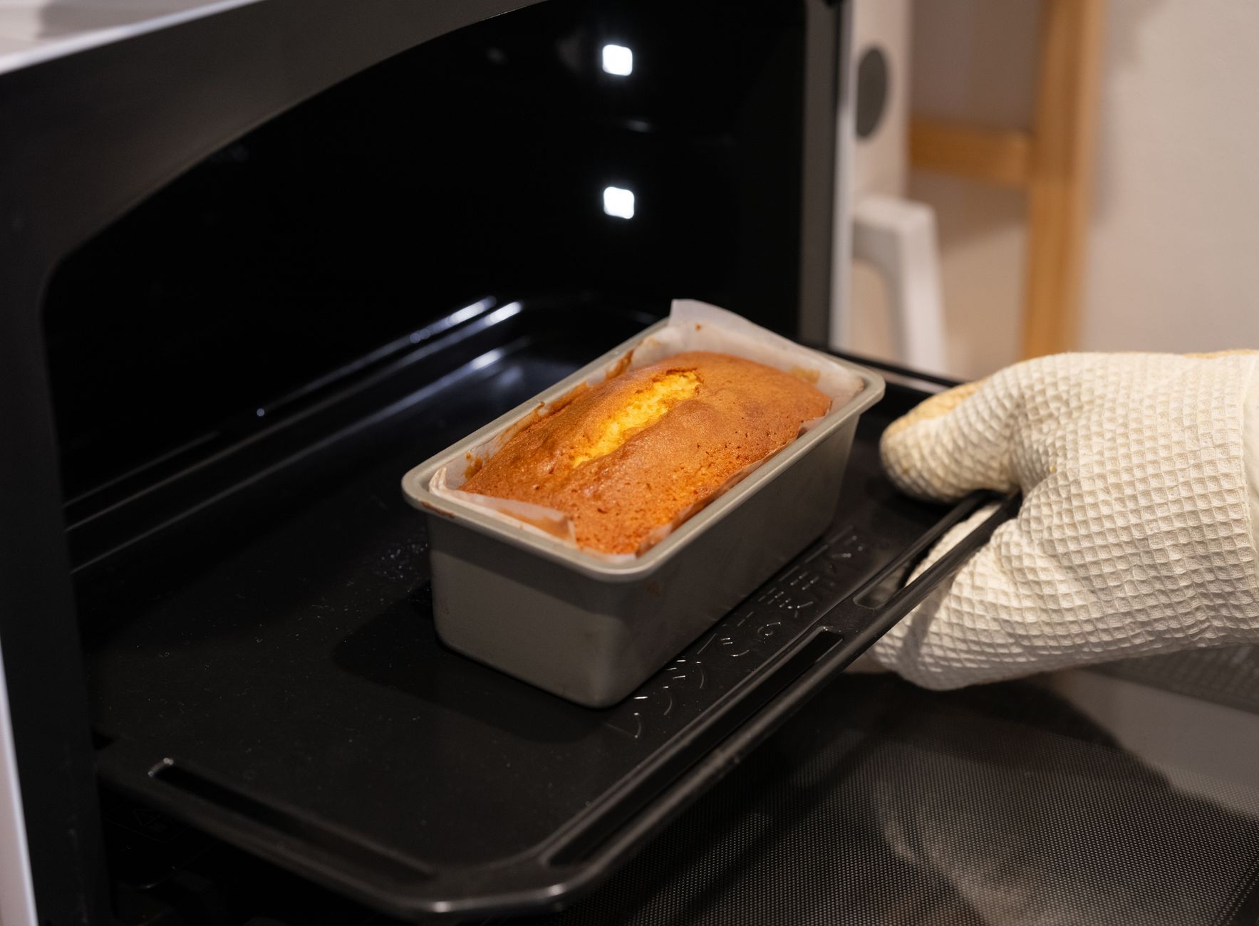 Two golden loaves of angel food cake in loaf pans