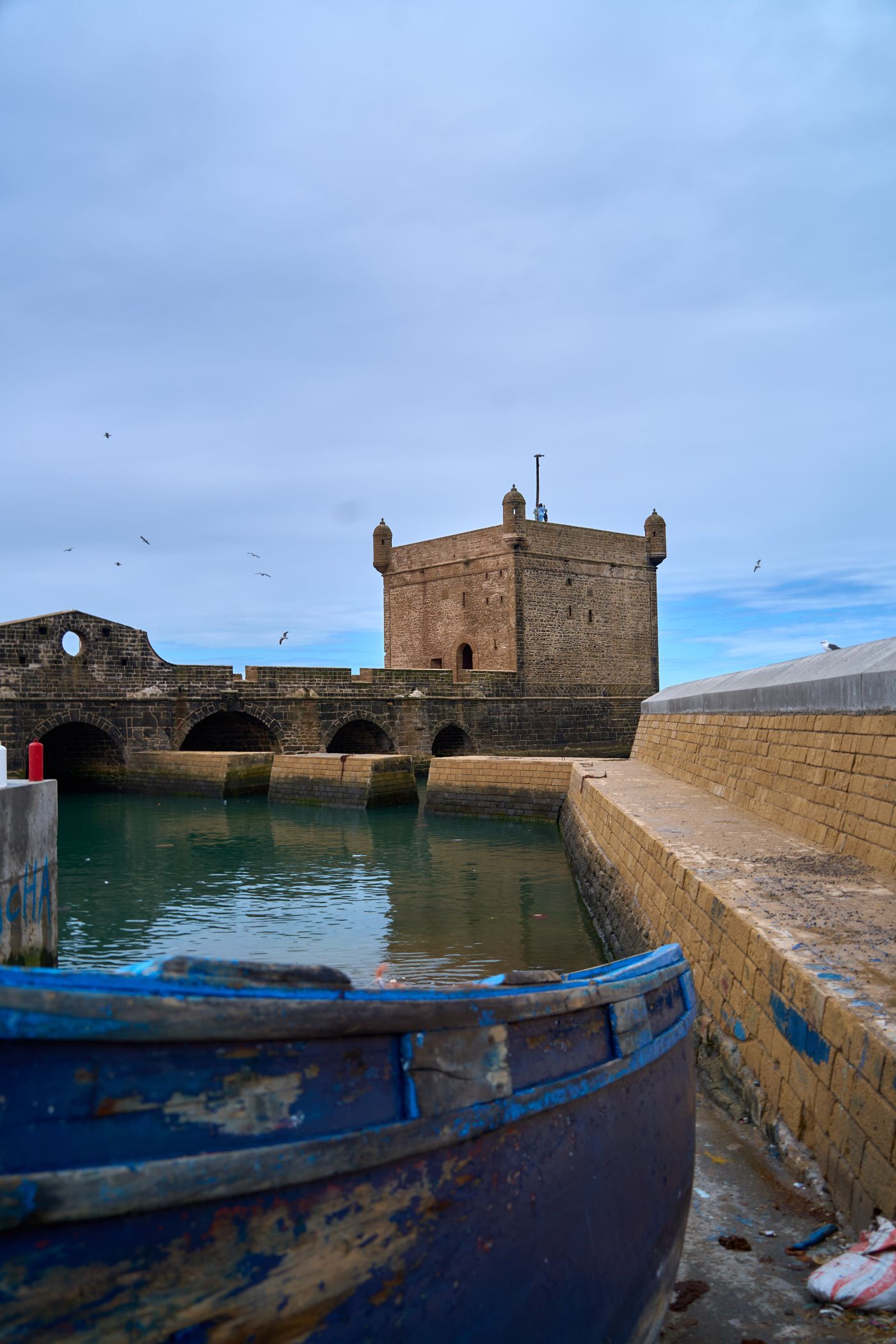 Historic bastion and boat beside Essaouira's fortified seafront