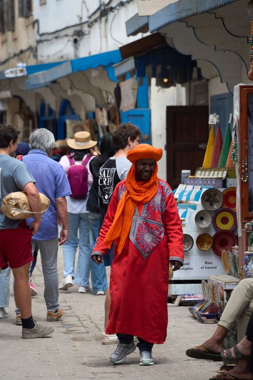 Free A vibrant street market in Essaouira, Morocco showcasing local culture and art. Stock Photo