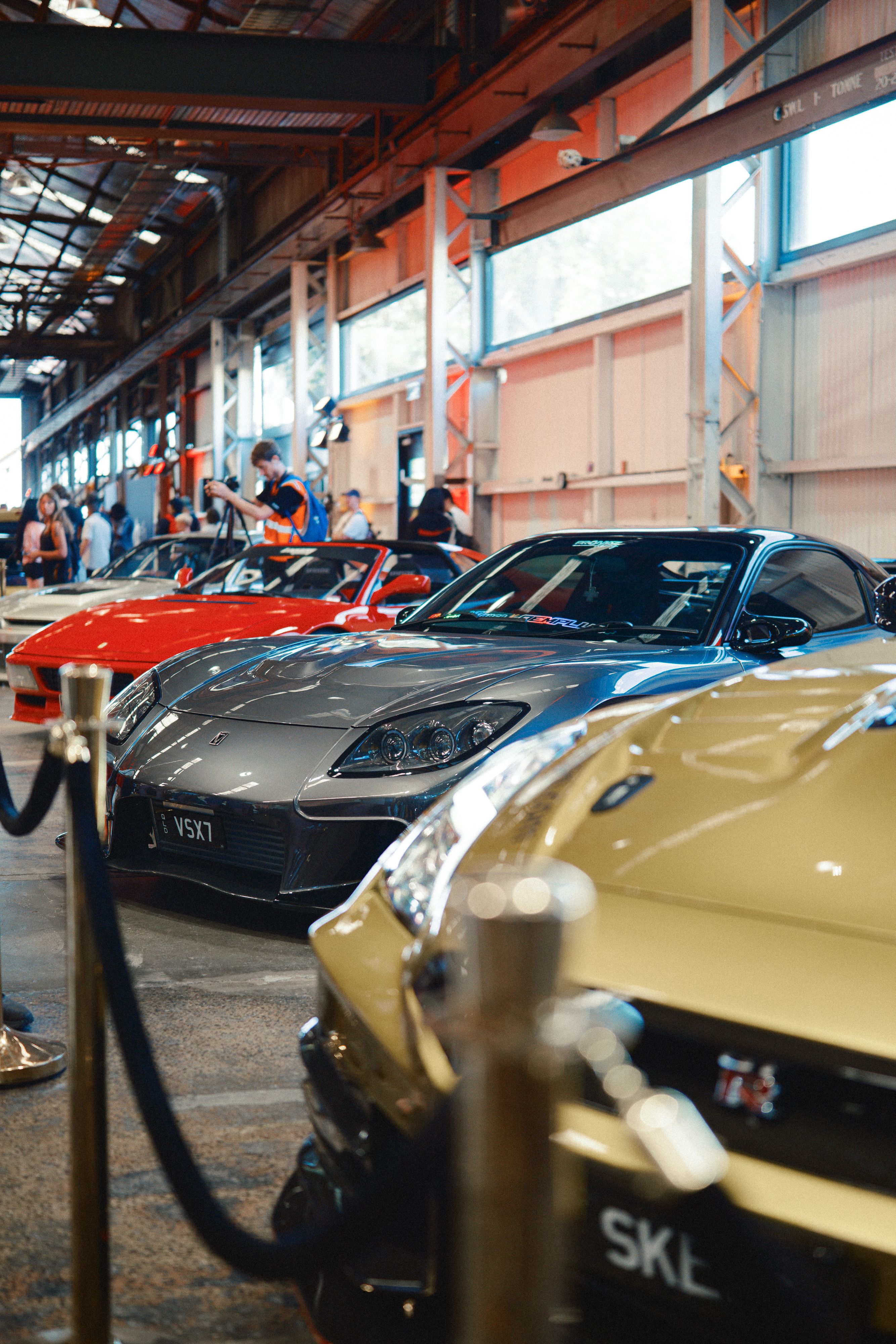 Luxury Sports Cars Display at Indoor Auto Show · Free Stock Photo