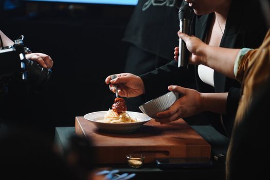 Close-up of a food photography session featuring spaghetti and meatballs.