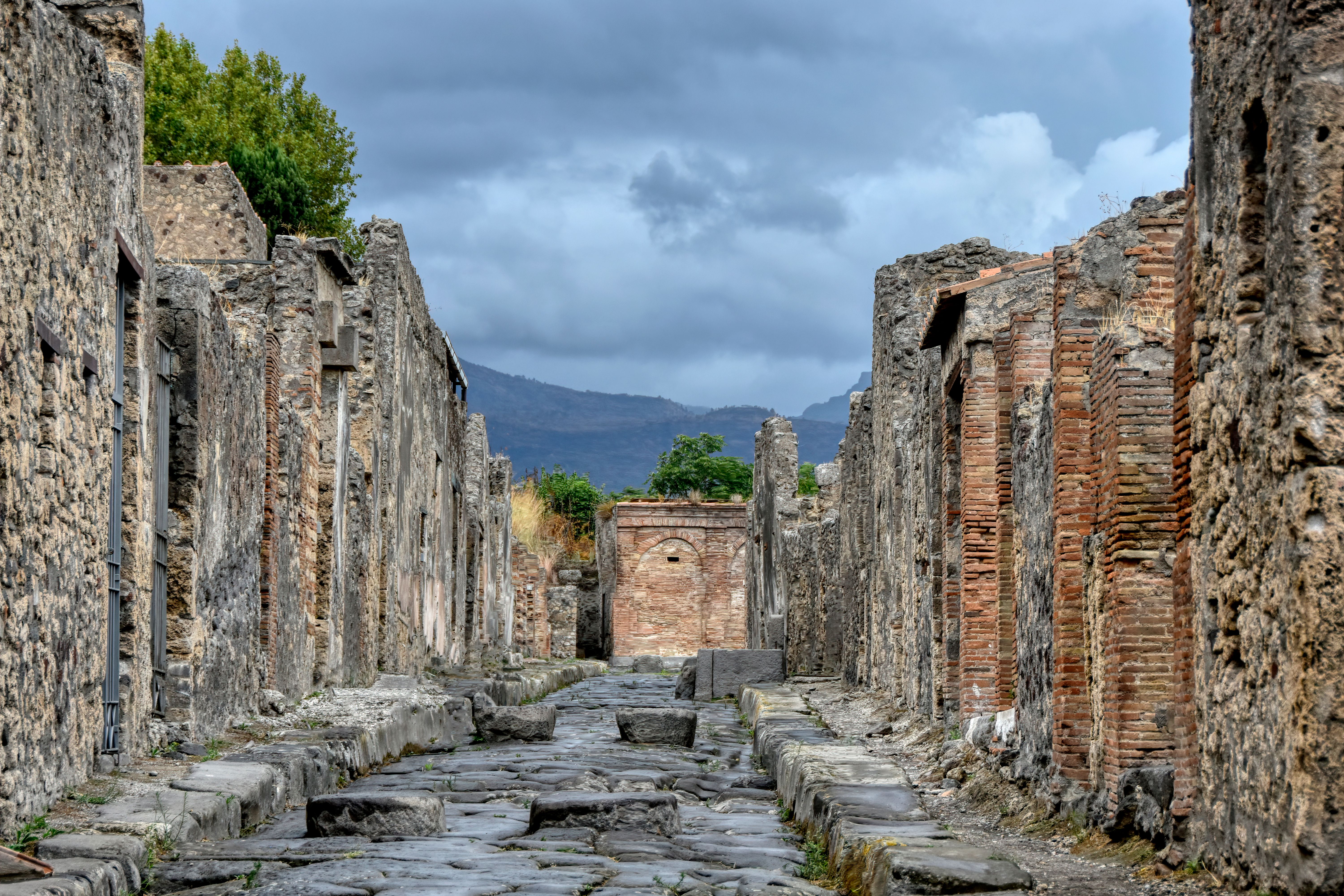 Ruins of Pompeii archaeological site with Mount Vesuvius in the background