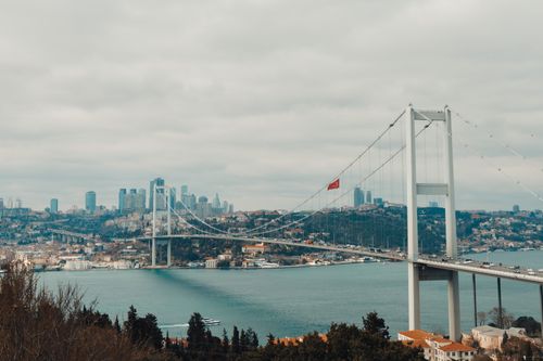Free Scenic view of the Bosphorus Bridge with city skyline and cloudy sky. Stock Photo