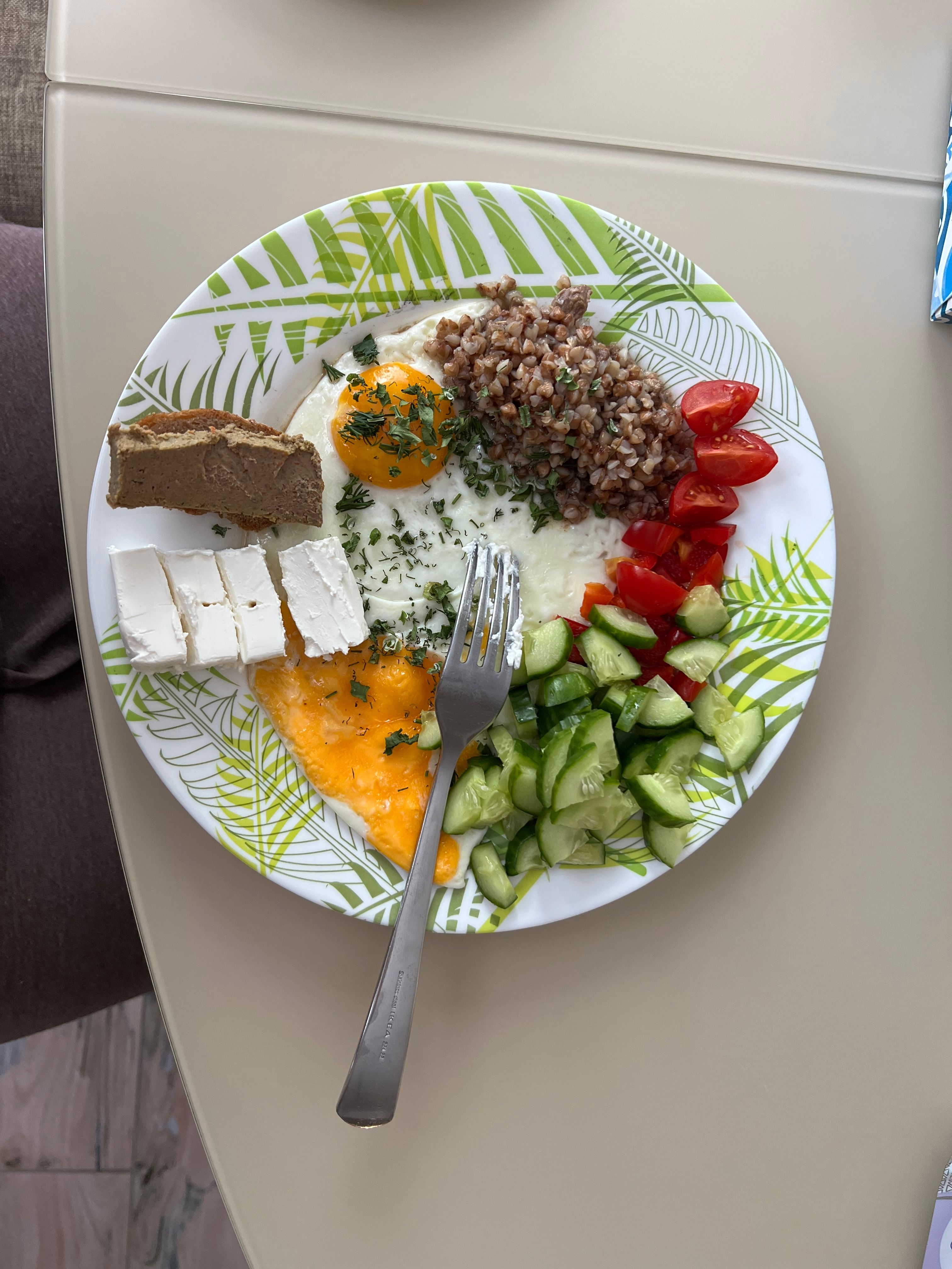 Vibrant Mediterranean breakfast with eggs, cheese, vegetables, and grains.