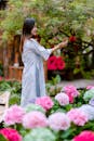 Woman Enjoying Blooming Garden in Spring