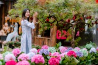 Woman Enjoying Garden Amongst Hydrangeas