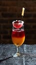 Vibrant Layered Cocktail with Fruit Garnish