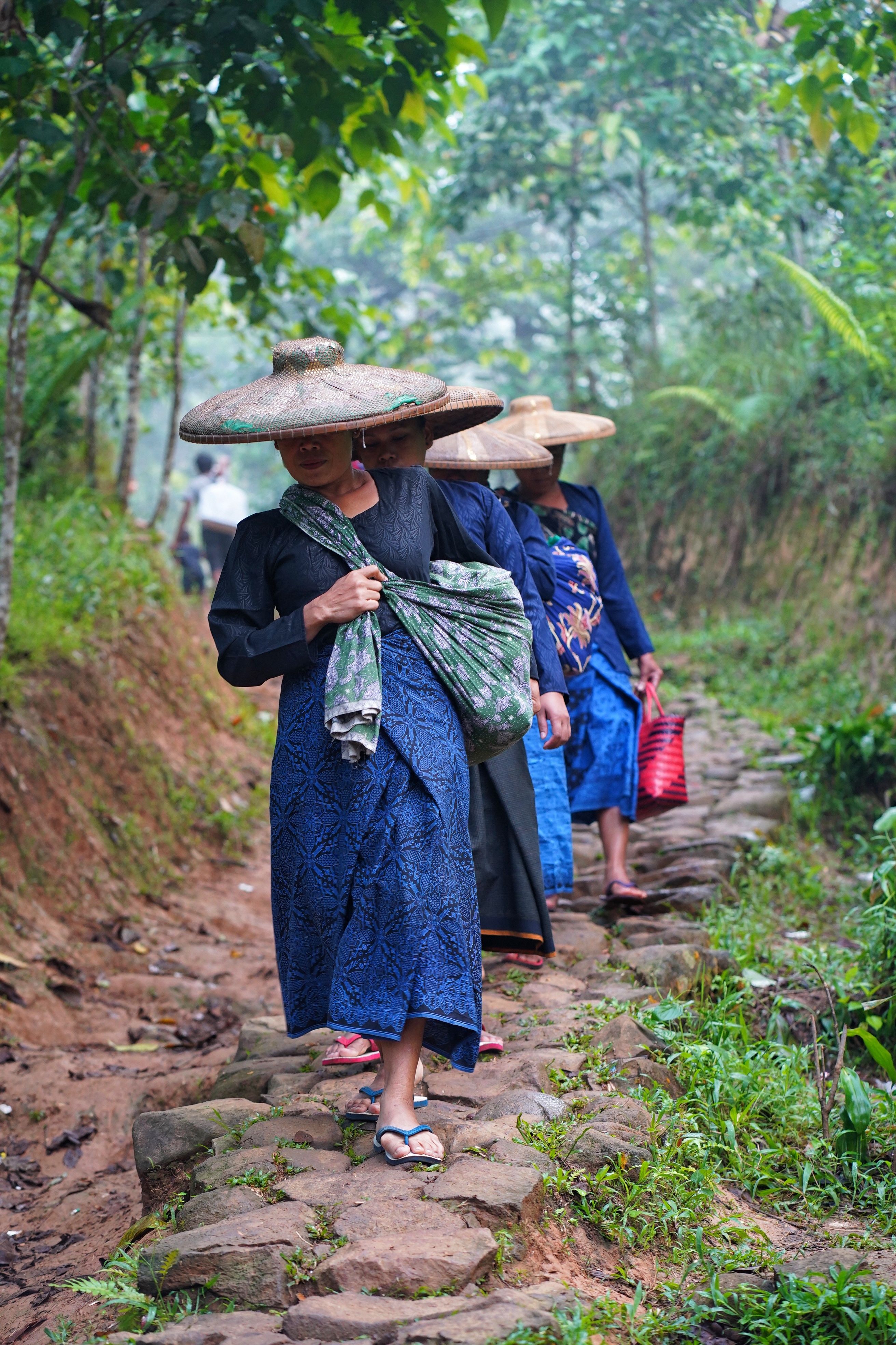 Traditional Indonesian Women Walking Through Lush Path · Free Stock Photo