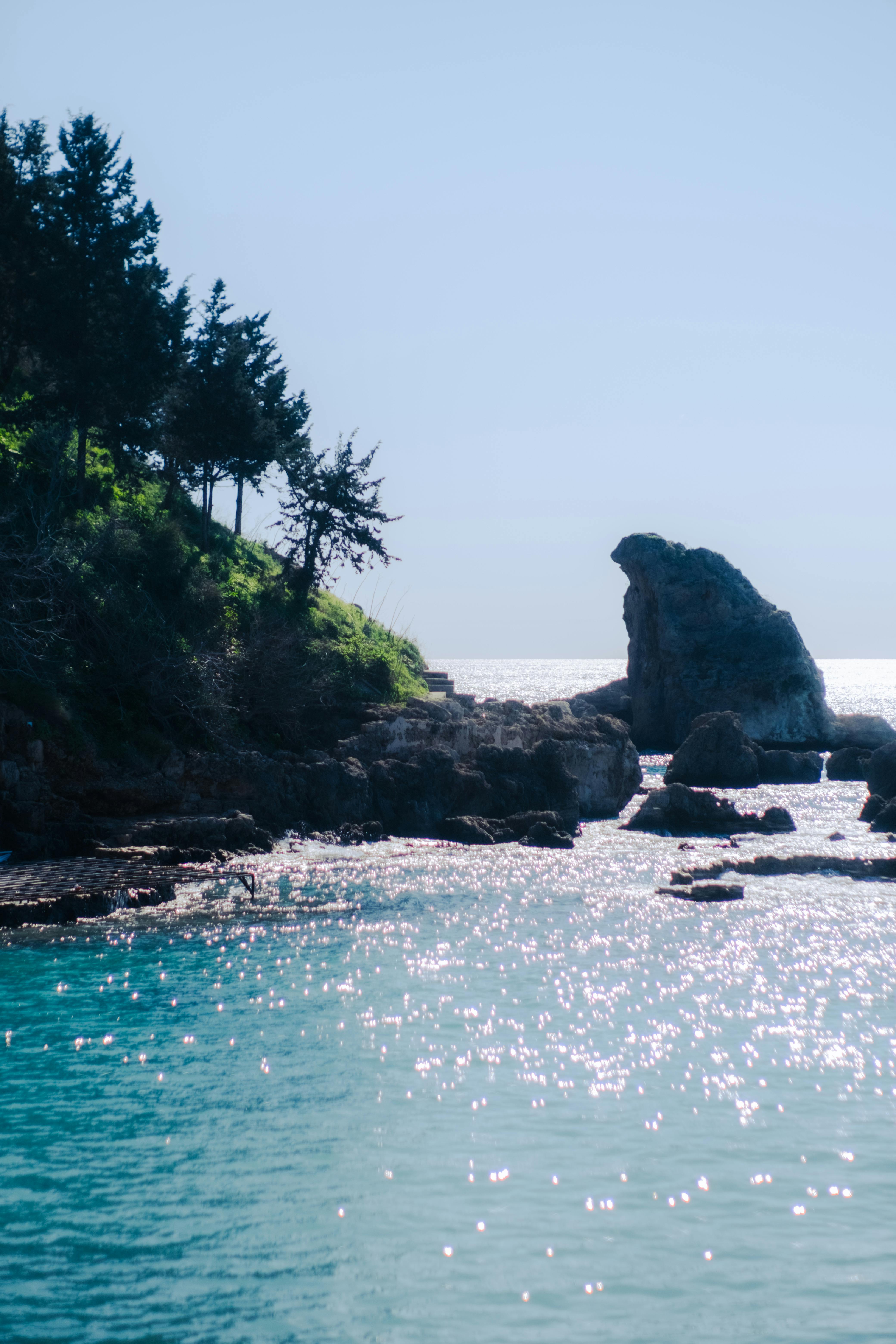 Zadarmo Malebná pobrežná scenéria s azúrovo modrými vodami a skalnatými útesmi, zachytená za denného svetla. Fotka z fotobanky