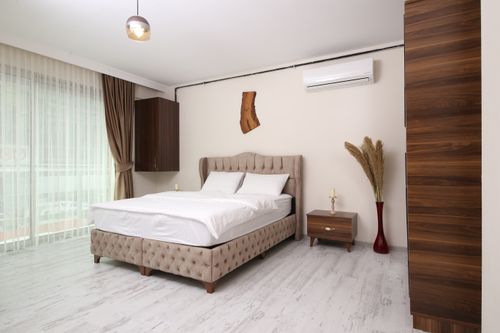 Free Bright and airy modern bedroom in Istanbul with minimalist design and luxury amenities. Stock Photo